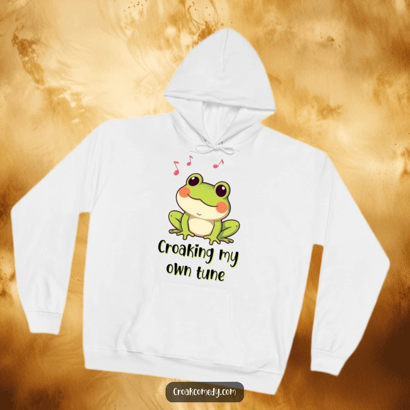 Funny Frog Hoodie: A cozy frog croaking a tune amidst musical notes, offering warmth and humorous amphibian charm.