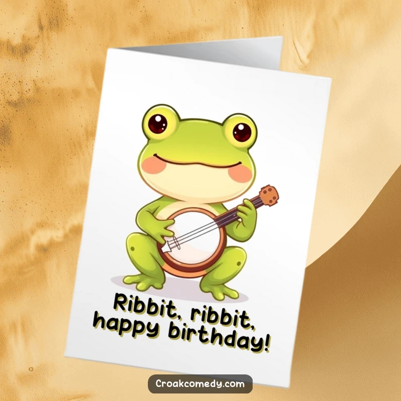 Funny Free Printable Birthday Card: Cheerful frog joyfully playing a tiny banjo, spreading birthday cheer.