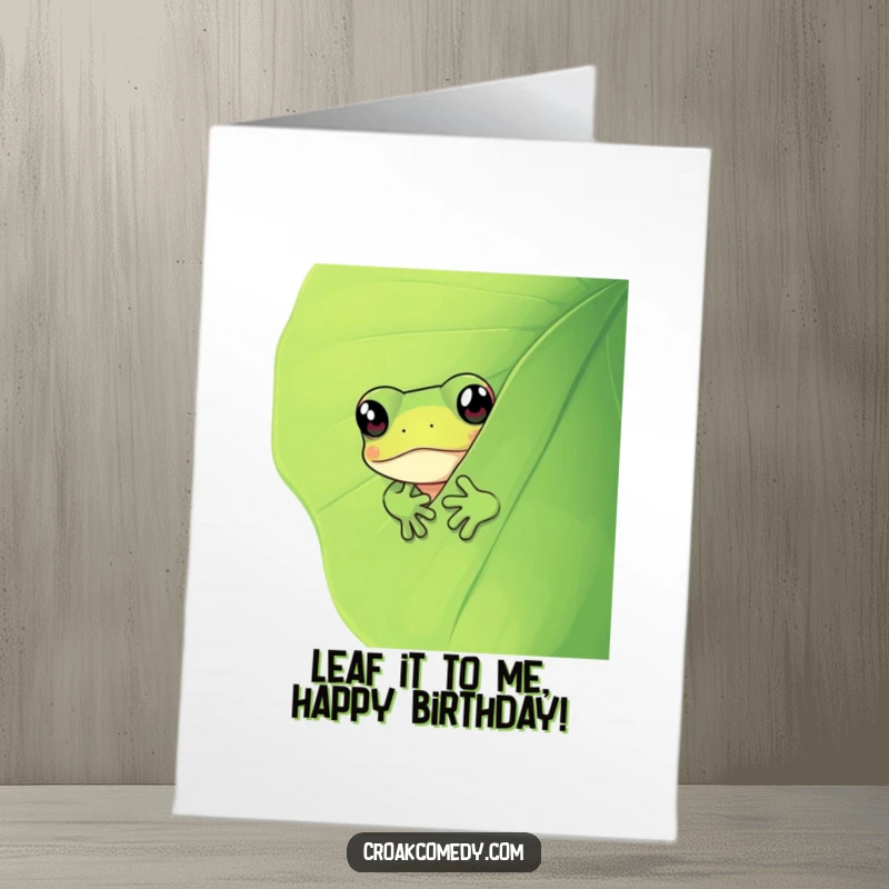 Funny Free Printable Birthday Card: Curious frog with wide eyes peeking from behind a giant green leaf.