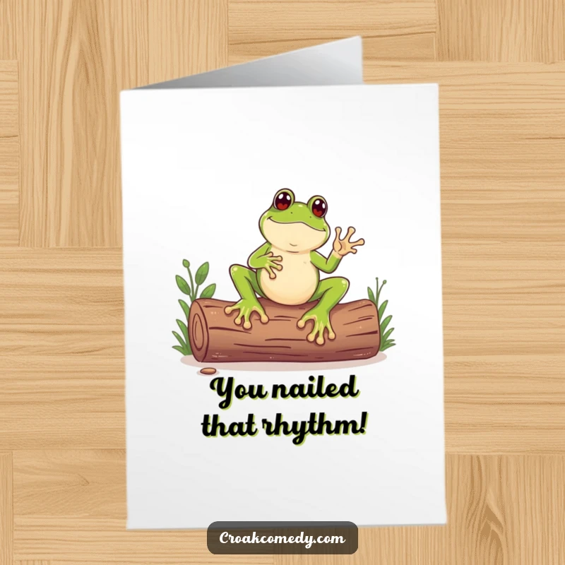 Funny Free Printable Congrats Card: A frog with large feet plays a beat on a log, celebrating a win.