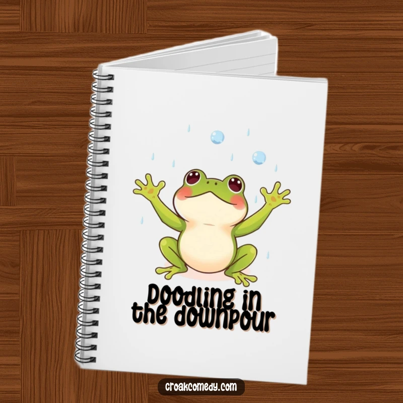Funny notebook with a small frog, arms outstretched, catching raindrops with delight, for writing.