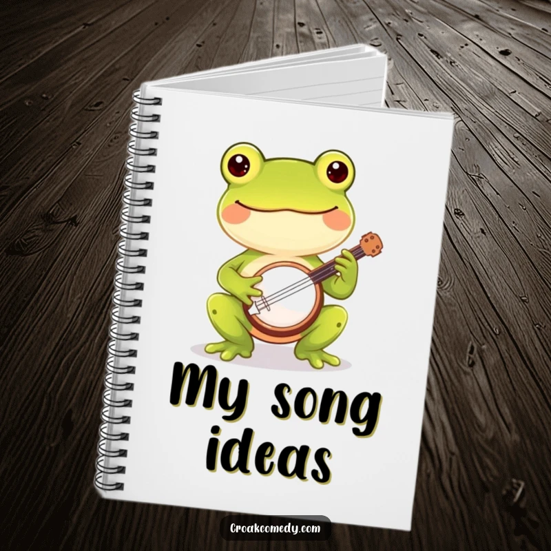 Funny frog notebook with a cheerful frog playing a banjo, ideal for humorous note-taking and music lovers.