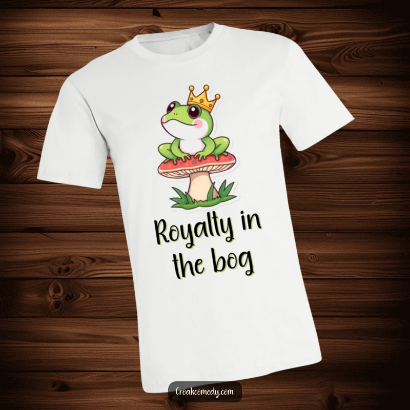 Funny T-Shirt: A frog adorned with a small crown sits majestically on a mushroom, looking quite distinguished.
