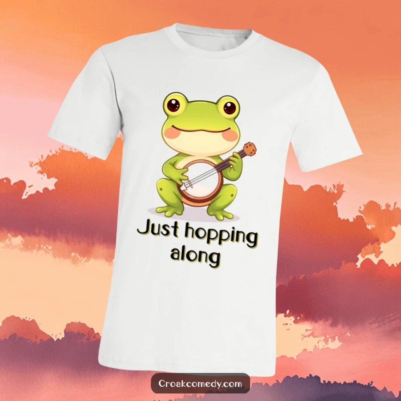 Funny cheerful frog t-shirt depicting a happy frog strumming a miniature banjo, perfect for music lovers and humor.
