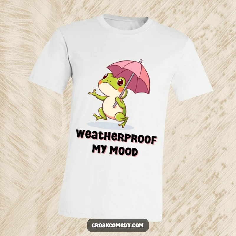 Funny cartoon frog cheerfully hopping with a small, colorful umbrella, printed on a t-shirt for a whimsical look.