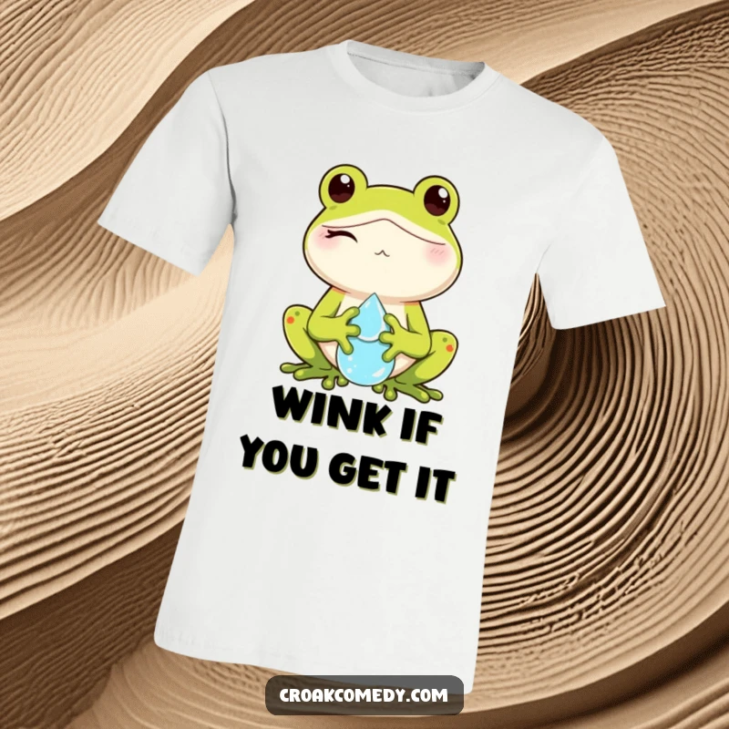 Funny t-shirt with a winking frog character holding a small, shimmering dewdrop, radiating playful charm.