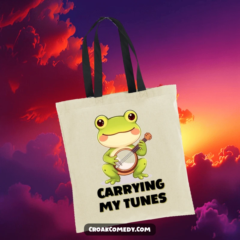 Funny frog tote bag showcasing a cheerful frog playing a small banjo, ideal for music lovers and humor enthusiasts.