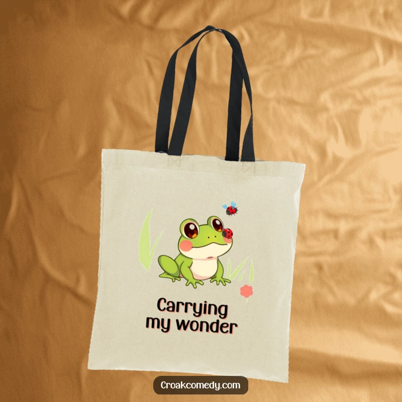 Funny tote bag featuring a frog with large, innocent eyes watching a ladybug fly, perfect for carrying essentials with charm.