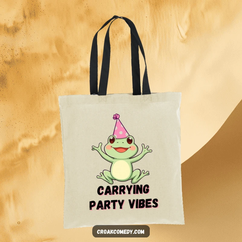 Funny tote bag featuring a frog adorned with a small party hat, joyfully leaping, perfect for carrying your celebration needs.